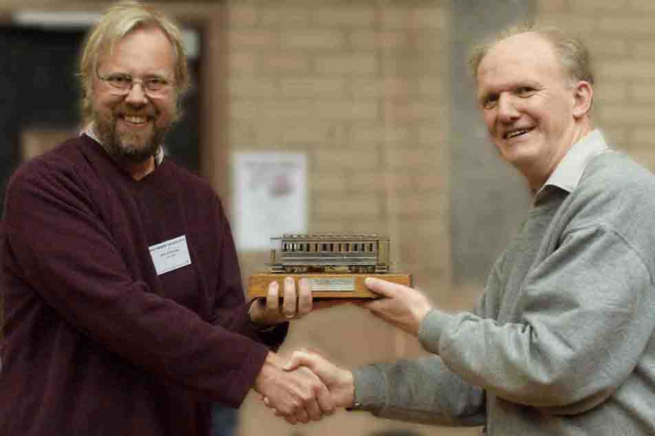 Giles Favell is presented the 2012 David Lloyd Trophy by Andrew Burnham